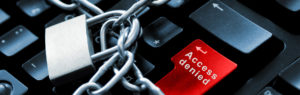 An image representing internet and computer security. The image showing a keyboard, a red 'Access Denied' button and a lock and chain